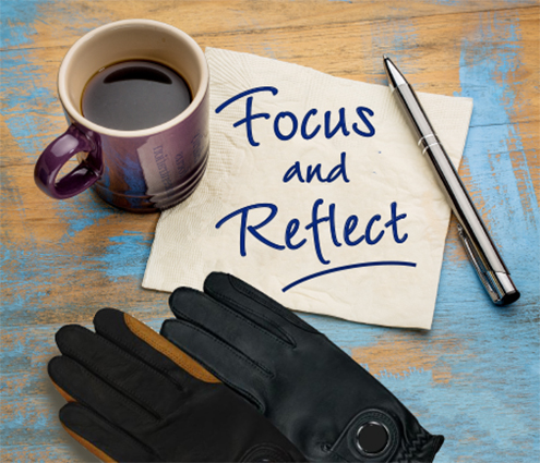 coffee, dressage riding gloves, and a note that says, "Focus and Reflect"